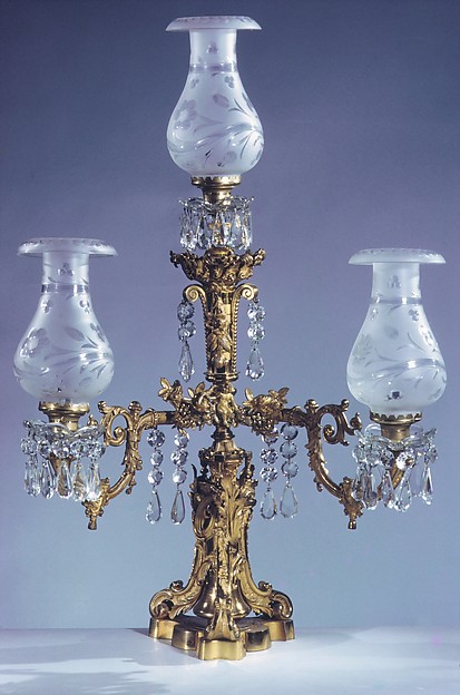 Ornate nineteenth-century gas lamp in a museum collection