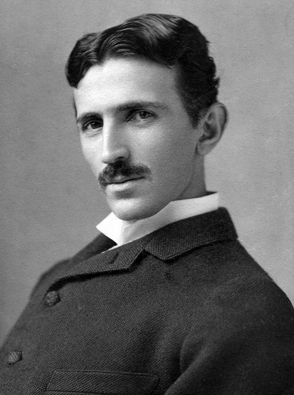Historical studio portrait of Nikola Tesla by Napoleon Sarony; Commons version has documented cleanup and tone adjustments.
